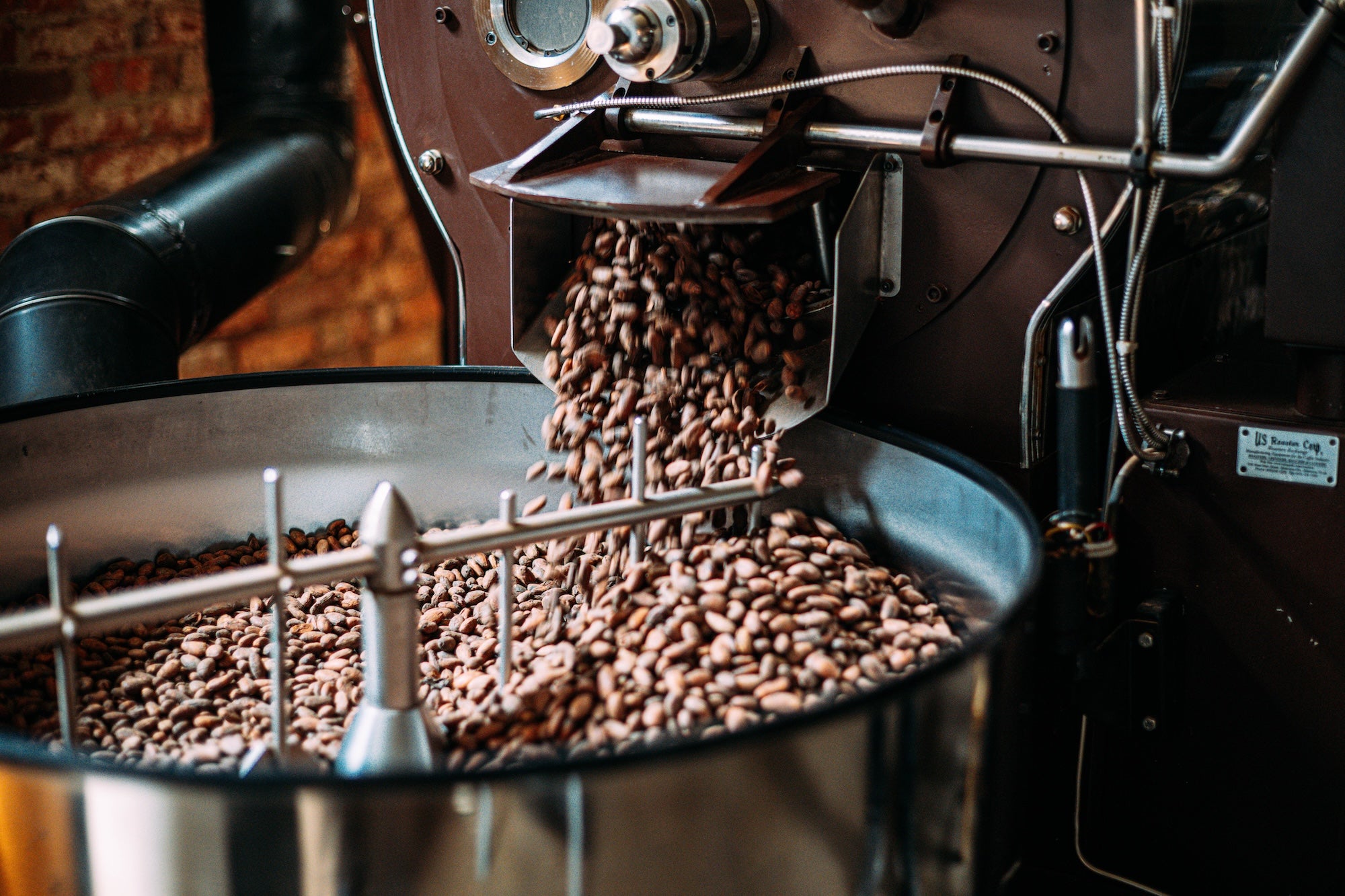 Chocolate beans being processed in bean roaster
