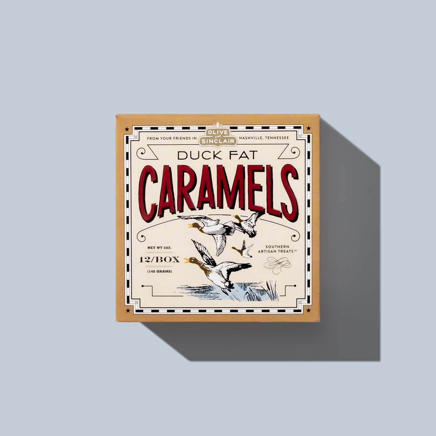 Box of Duck Fat Caramels on a light blue background