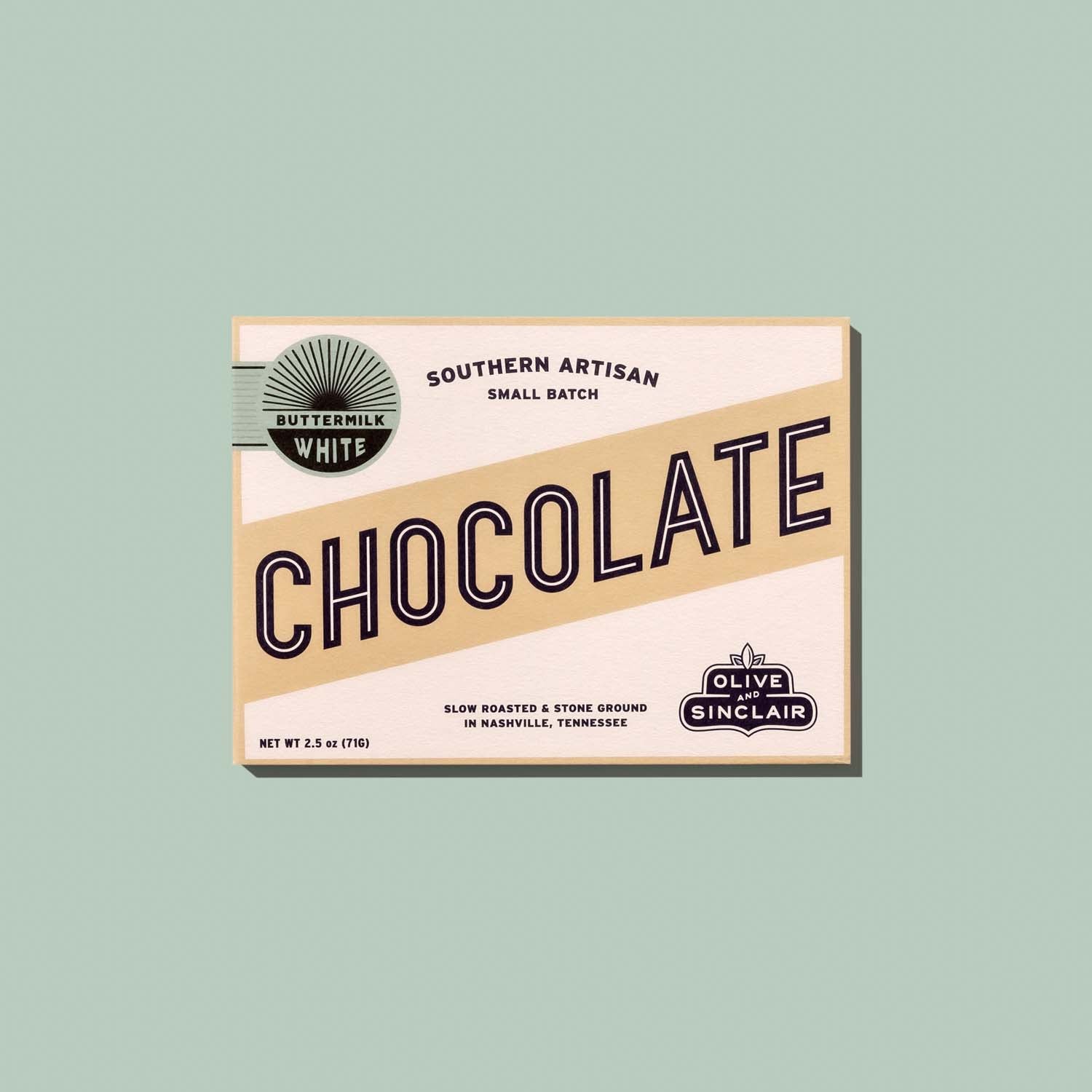 Box of Olive Sinclair white chocolate on a light green background