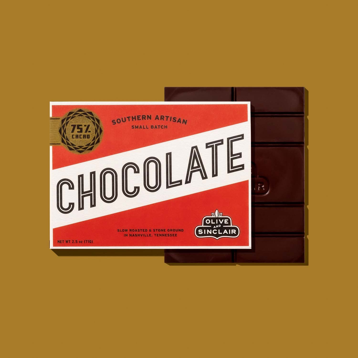 Bar of Olive Sinclair chocolate with packaging on a gold background 