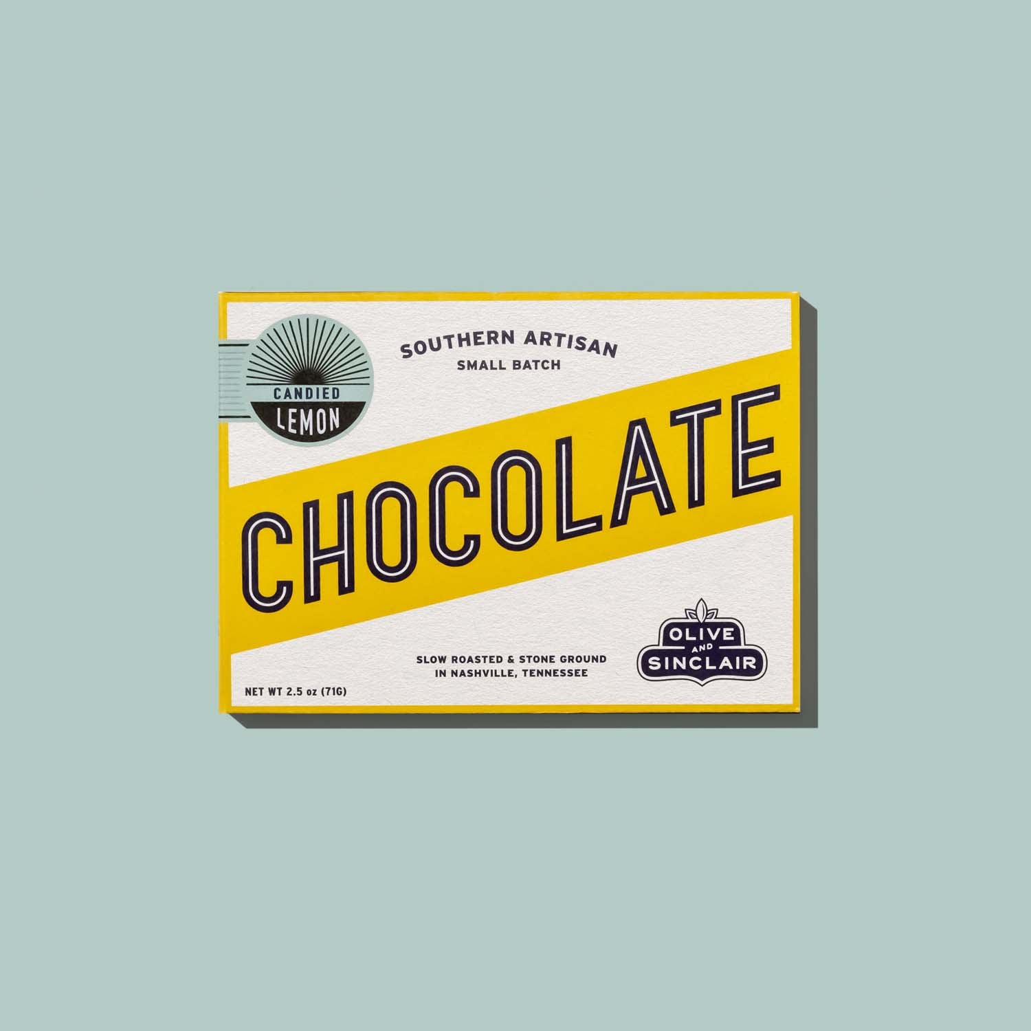 bar of Olive Sinclair candied lemon chocolate on a light blue background