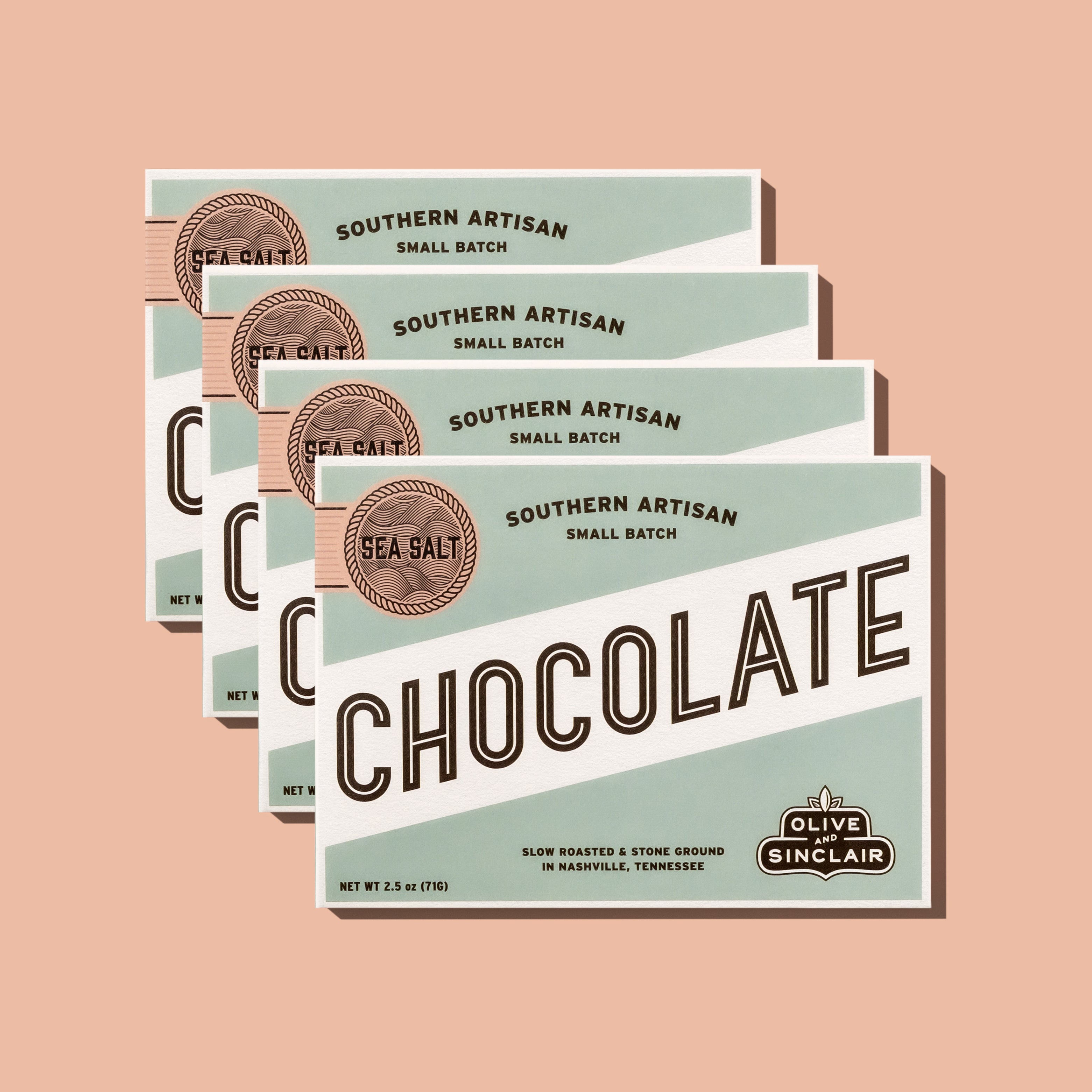 Multiple packages of Southern Artisan Chocolate on a peach background
