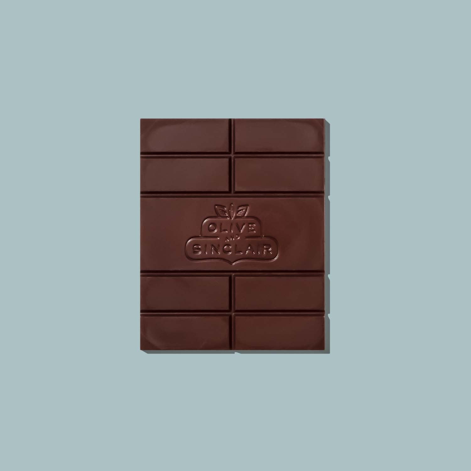 Chocolate bar with an Olive and Sinclair brand logo on a light blue background