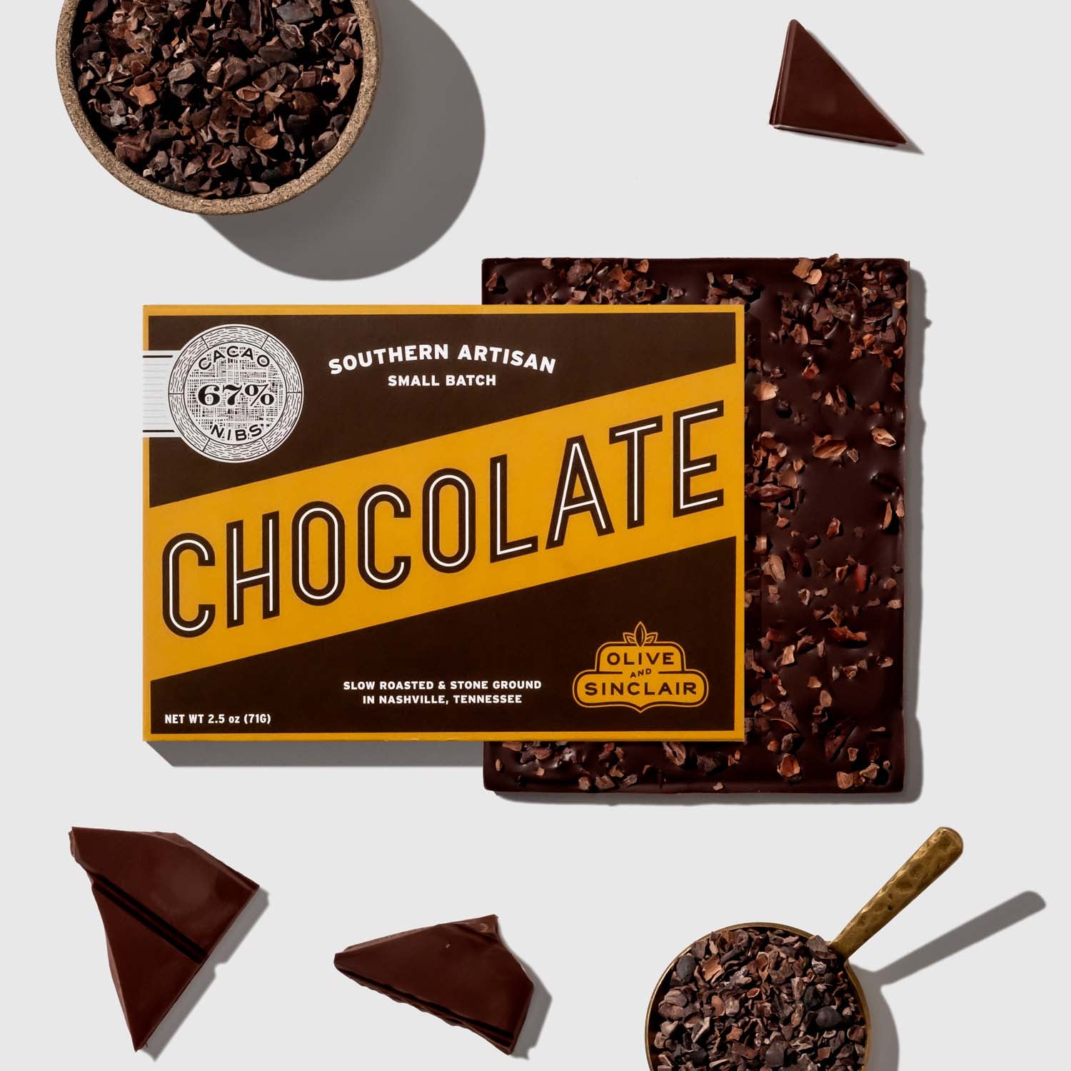 Box of cacao nibs chocolate with cacao nibs on a white background