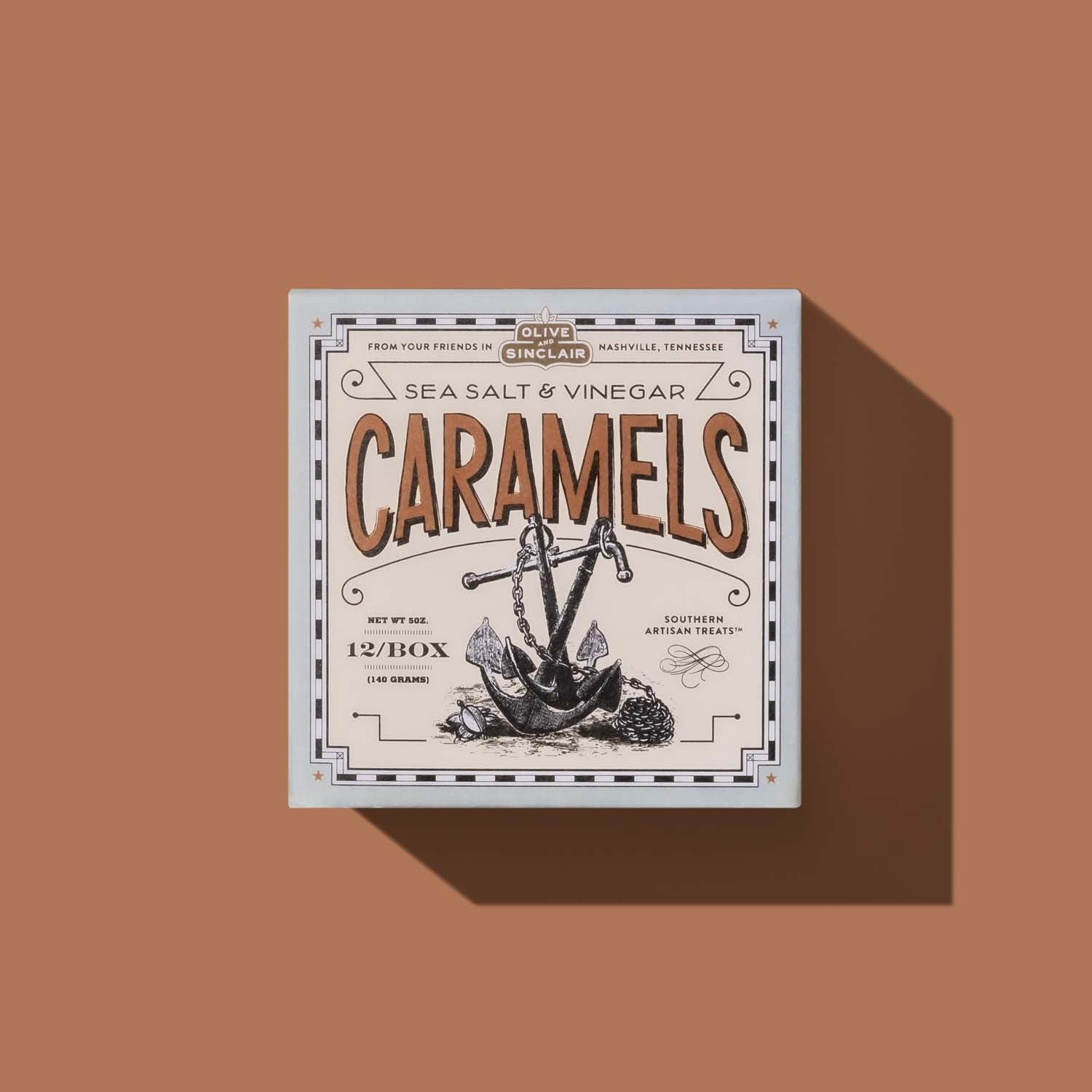 Box of sea salt and vinegar caramels on a brown background